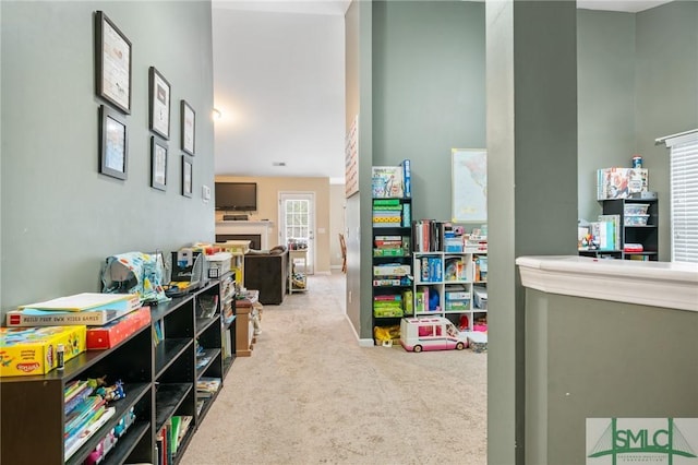 recreation room featuring light colored carpet