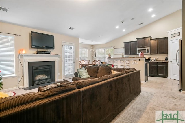 carpeted living room featuring vaulted ceiling