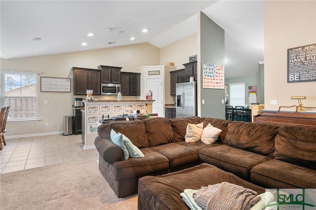 living room with light tile patterned floors and high vaulted ceiling