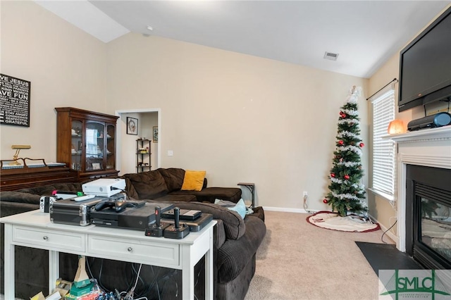 living room featuring lofted ceiling and carpet floors