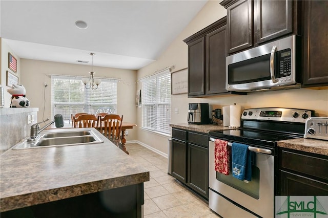 kitchen with appliances with stainless steel finishes, sink, dark brown cabinetry, and decorative light fixtures