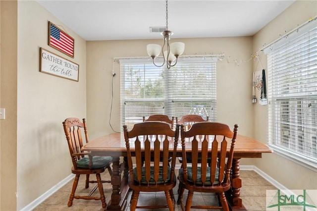 dining area featuring light tile patterned floors and a chandelier