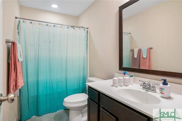 bathroom with vanity, toilet, and walk in shower