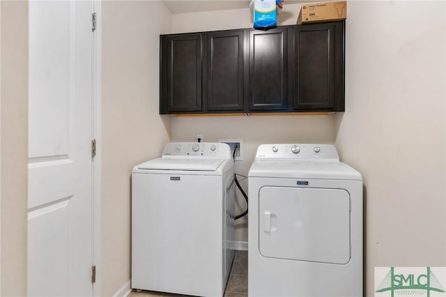 laundry area with cabinets and washing machine and dryer