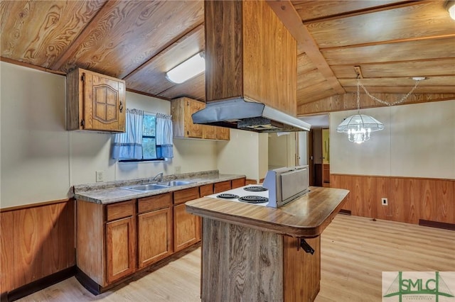 kitchen with sink, ventilation hood, vaulted ceiling, hanging light fixtures, and wooden ceiling