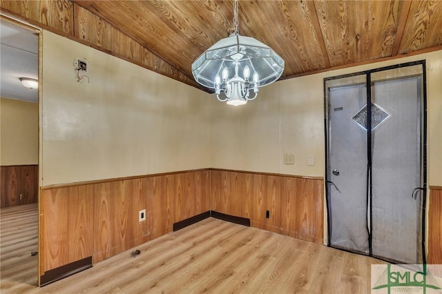 unfurnished dining area with lofted ceiling, a chandelier, hardwood / wood-style floors, and wood ceiling