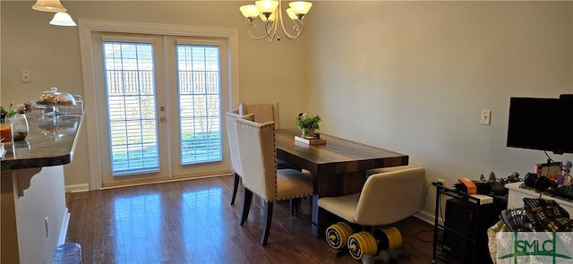 dining space featuring an inviting chandelier, dark wood-type flooring, and french doors