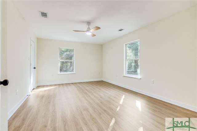 empty room with ceiling fan and light hardwood / wood-style flooring