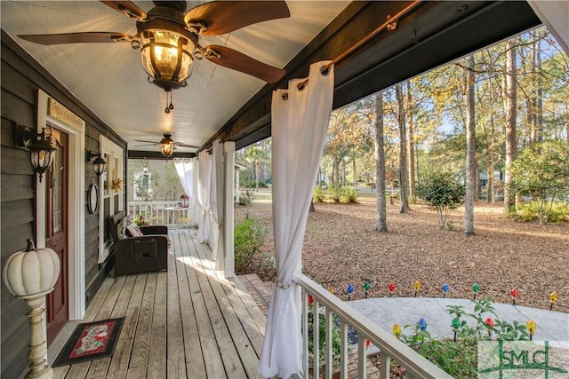 wooden deck with ceiling fan and a porch