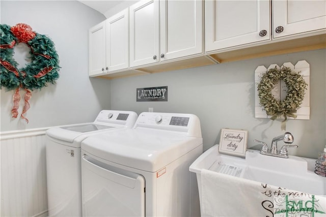 washroom featuring cabinets, washer and clothes dryer, and sink