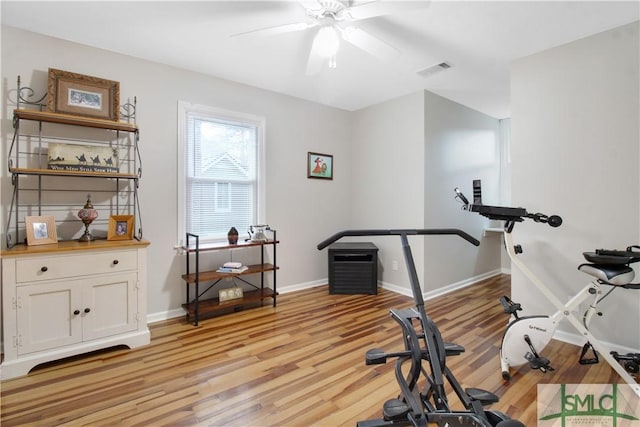 exercise room featuring ceiling fan and light wood-type flooring