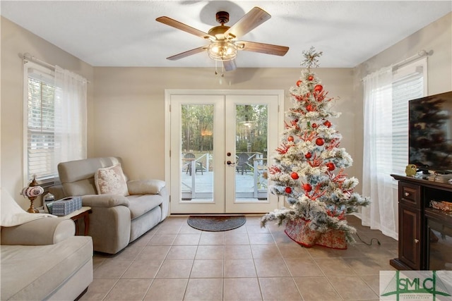 entryway featuring light tile patterned flooring, ceiling fan, french doors, and a wealth of natural light