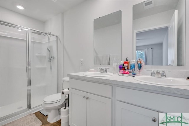 176 Coneflower Rd, Bloomingdale, GA 31302 - bathroom with hardwood / wood-style flooring, vanity, an enclosed shower, and toilet