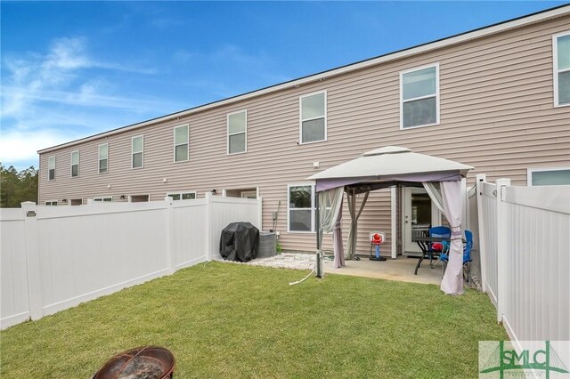 176 Coneflower Rd, Bloomingdale, GA 31302 - rear view of house with a gazebo, a fire pit, and a lawn