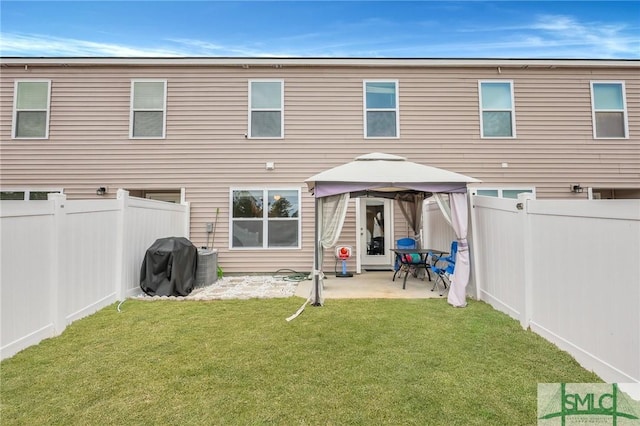 176 Coneflower Rd, Bloomingdale, GA 31302 - rear view of property featuring a gazebo, a patio, central AC, and a lawn