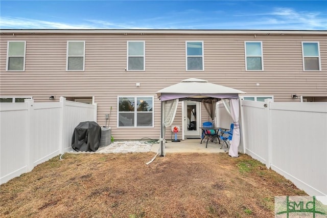 176 Coneflower Rd, Bloomingdale, GA 31302 - back of property with a gazebo, a patio, and a lawn