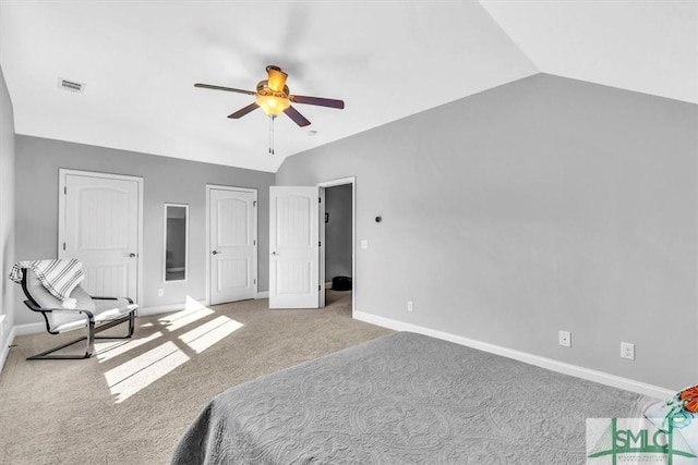 carpeted bedroom with ceiling fan and vaulted ceiling