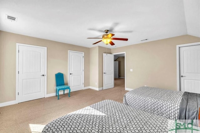 carpeted bedroom featuring lofted ceiling and ceiling fan