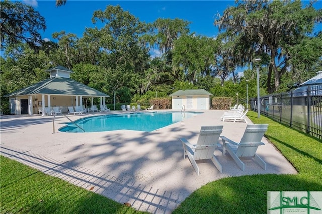 view of pool with a gazebo, a shed, and a patio