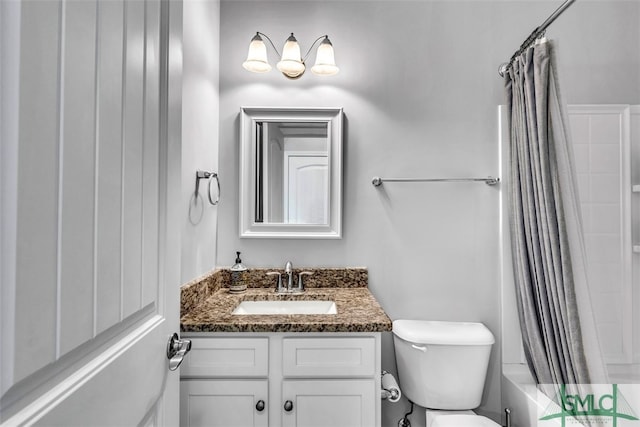 full bathroom with vanity, shower / tub combo, and toilet