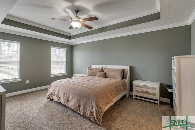 carpeted bedroom featuring a textured ceiling, ornamental molding, a raised ceiling, and ceiling fan