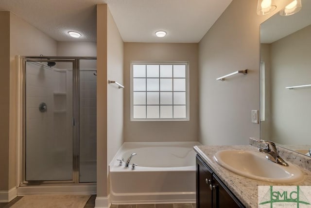 bathroom with vanity, tile patterned floors, and independent shower and bath