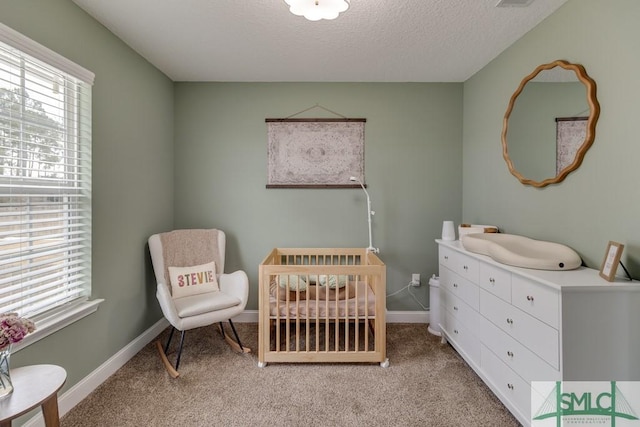 bedroom featuring light carpet, multiple windows, and a nursery area