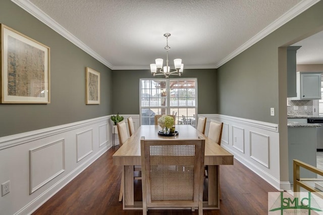 dining room with dark hardwood / wood-style flooring, crown molding, a textured ceiling, and a chandelier