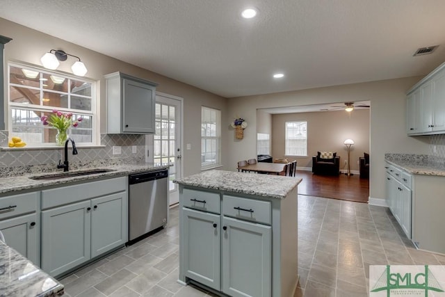 kitchen featuring gray cabinets, dishwasher, and sink