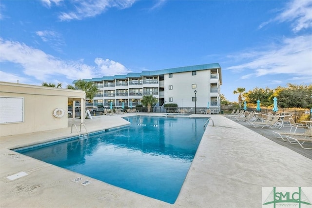 pool featuring a patio area and fence