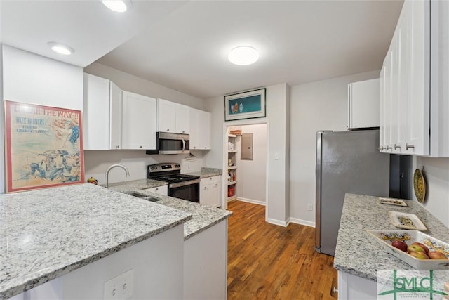 kitchen featuring appliances with stainless steel finishes, light stone countertops, sink, and white cabinets