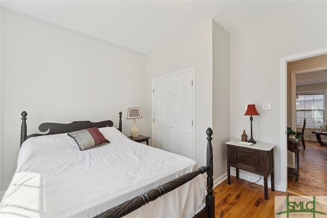 bedroom with hardwood / wood-style flooring and a closet