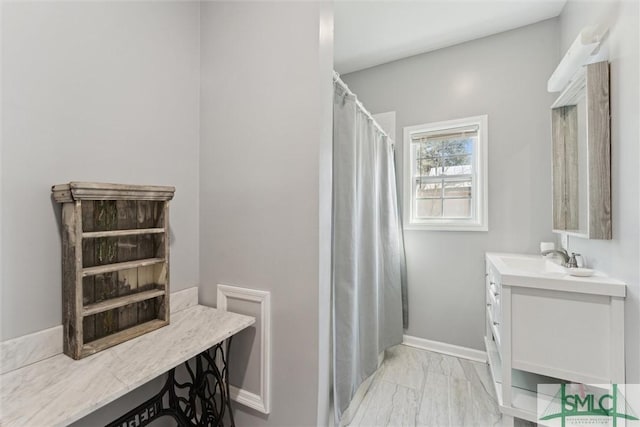 bathroom with walk in shower and vanity