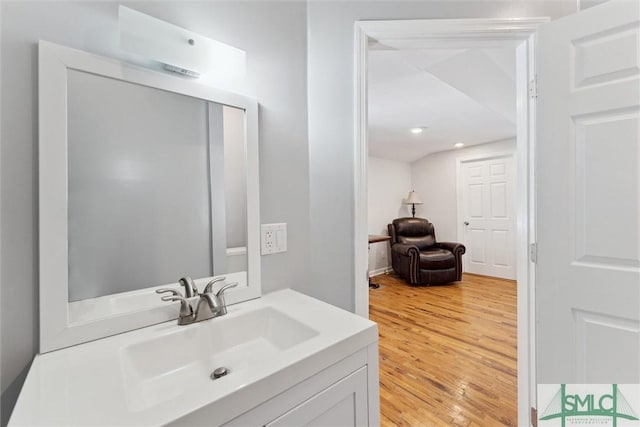 bathroom with vanity and hardwood / wood-style flooring