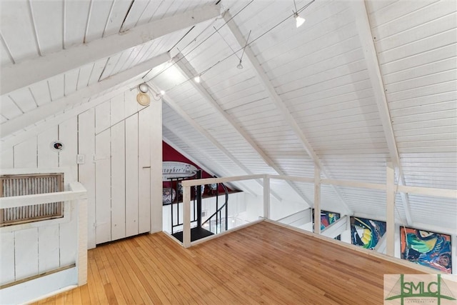 bonus room with vaulted ceiling with beams and hardwood / wood-style flooring