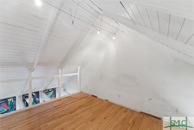 bonus room featuring hardwood / wood-style flooring and vaulted ceiling with beams