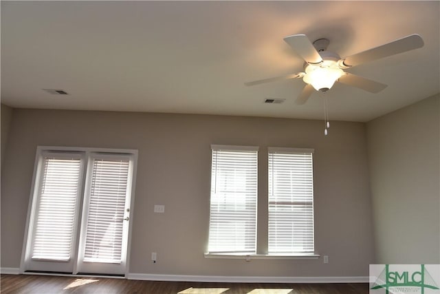 unfurnished room with dark hardwood / wood-style floors and ceiling fan