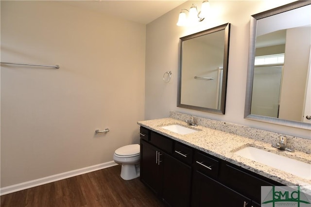 bathroom featuring vanity, toilet, and hardwood / wood-style floors