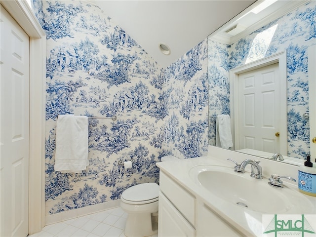 bathroom featuring tile patterned flooring, vanity, and toilet