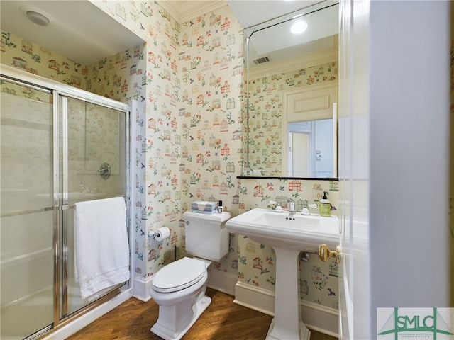 bathroom with toilet, wood-type flooring, ornamental molding, and walk in shower