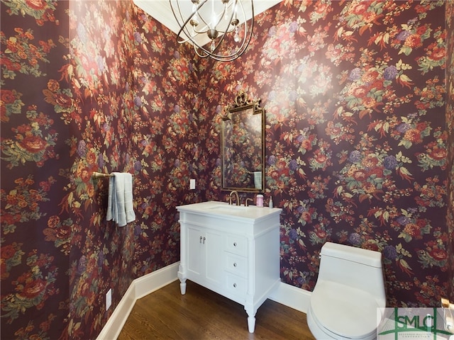 bathroom featuring wood-type flooring, toilet, and vanity