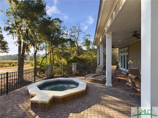 view of swimming pool featuring a patio, an in ground hot tub, and ceiling fan