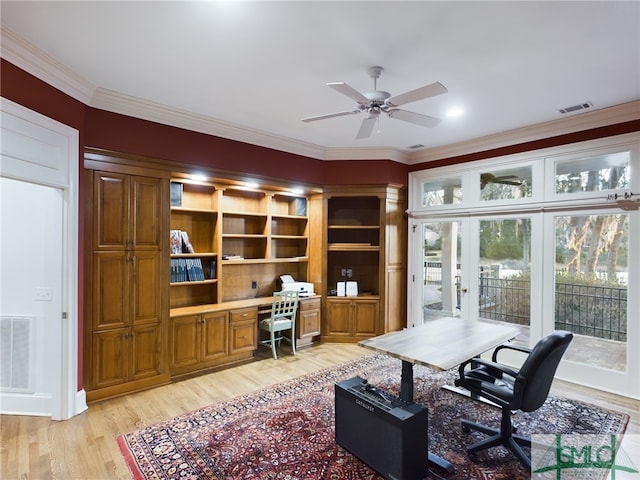 office featuring ceiling fan, ornamental molding, built in desk, and light wood-type flooring