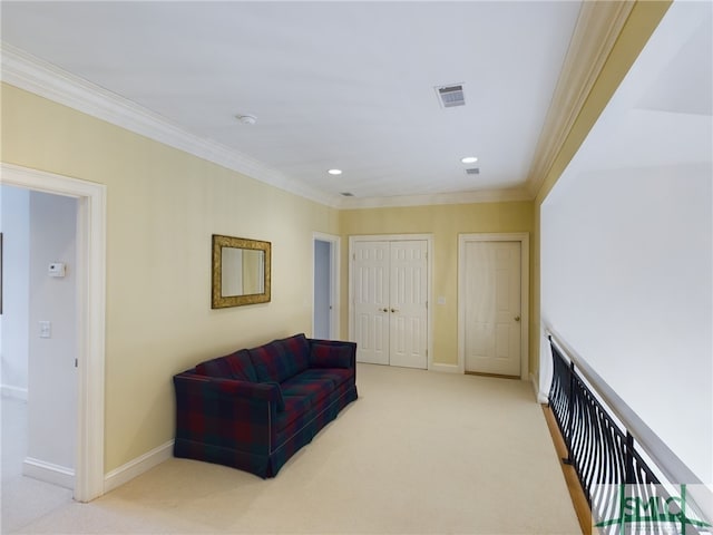 living area with ornamental molding and light carpet