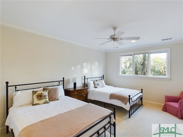 bedroom featuring crown molding, light colored carpet, and ceiling fan