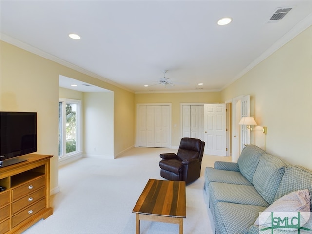 carpeted living room featuring crown molding and ceiling fan