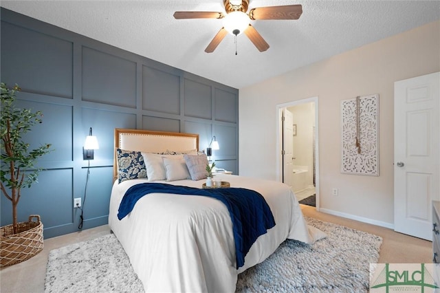 carpeted bedroom with connected bathroom, a textured ceiling, and ceiling fan