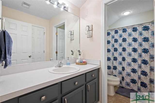 bathroom with vanity, tile patterned floors, a textured ceiling, and toilet