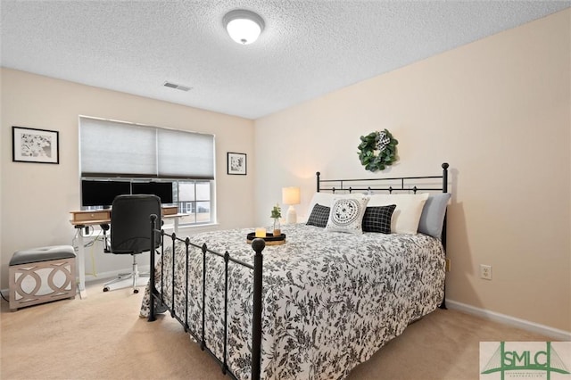 carpeted bedroom featuring a textured ceiling