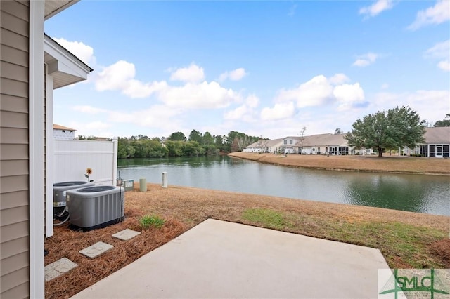 view of patio / terrace featuring a water view and cooling unit